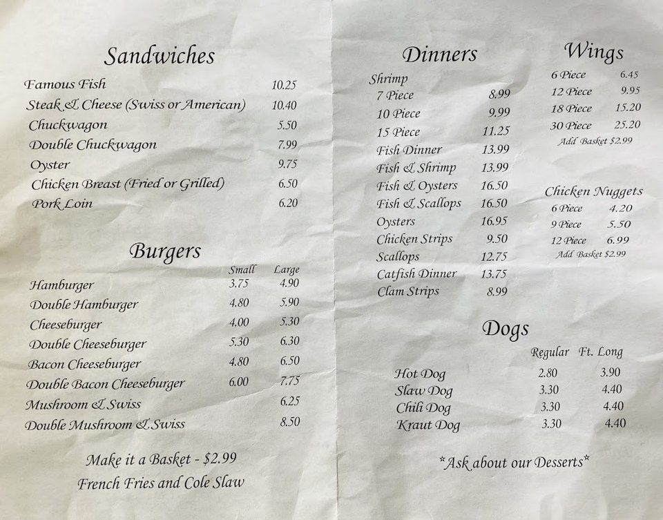 Menu-style spread of seafood sandwiches and sides.